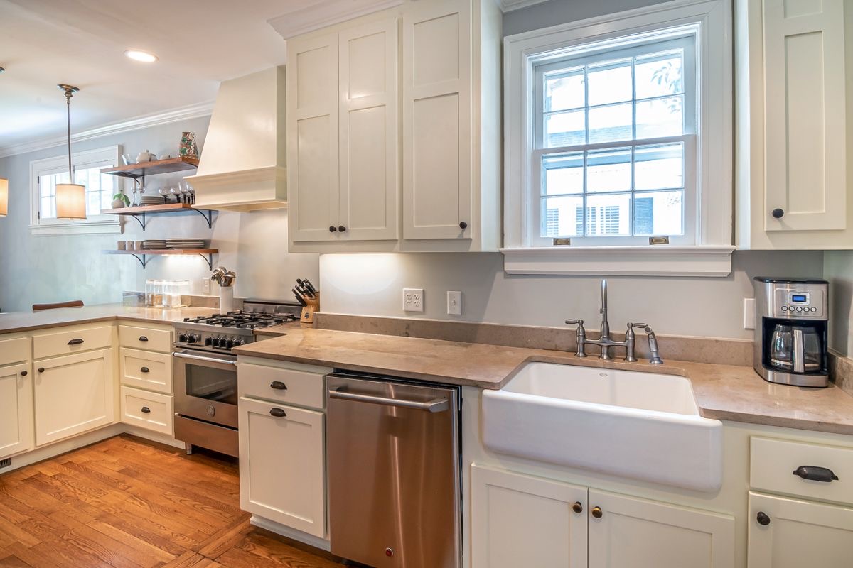 Classic white kitchen with farmhouse sink in a newly built home