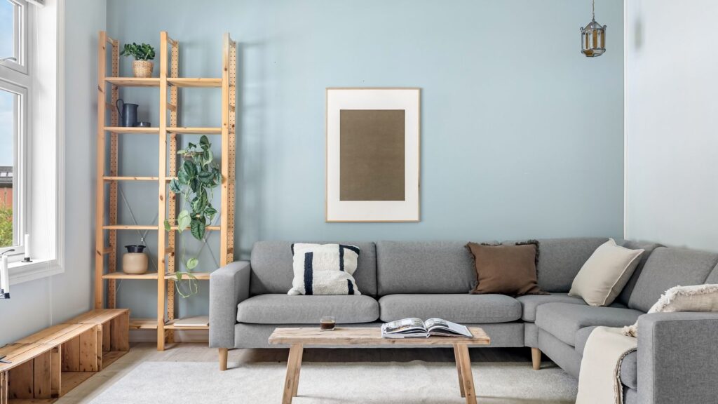 A cozy Scandinavian living room with modern gray couch and wooden elements.