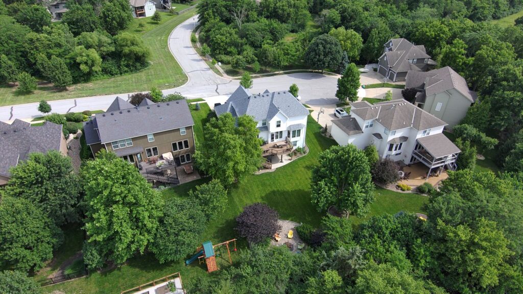 Aerial image showcasing a lush suburban neighborhood with well-maintained lawns and houses.