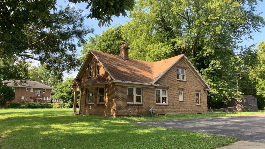 Charming brick house surrounded by trees in a quiet Decatur neighborhood. Perfect for real estate and lifestyle imagery.