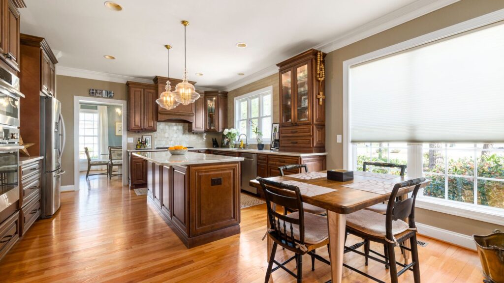 Elegant kitchen featuring wooden cabinets, island, and natural light.
